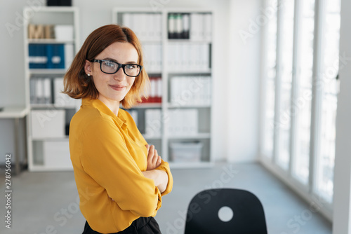 Schilderij op canvas Smiling friendly self-assured young businesswoman