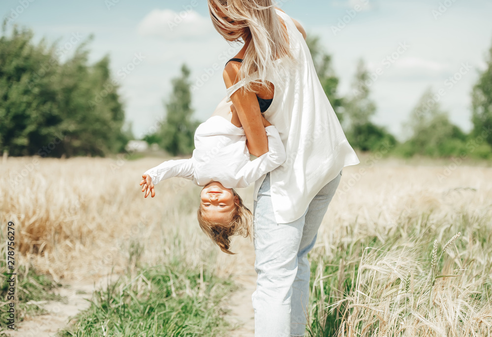 Child headfirst. Happy family playing in nature.