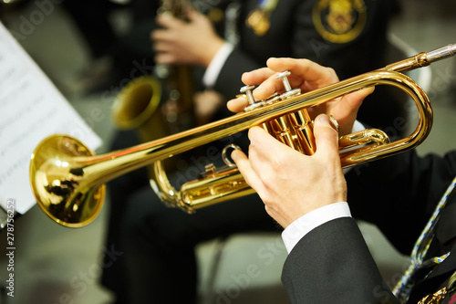 The trumpeter is playing on a silver trumpet. Trumpet players