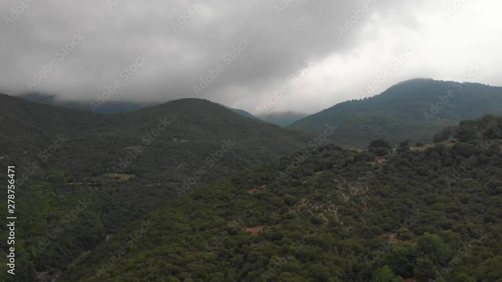 Aerial panning shot of cloudy paggaion mountain. Windy day Aerial panning shot of cloudy paggaion mountain. Windy day