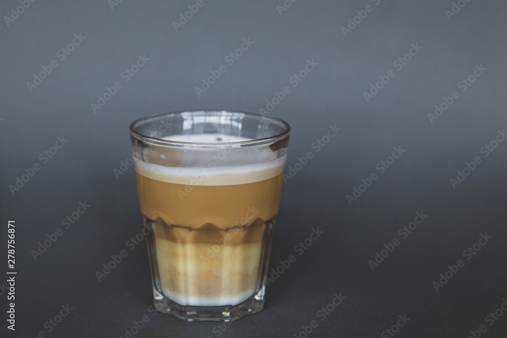 large transparent glass filled with of aromatic coffee photographed on the isolated gray background picture for the menu. large transparent glass filled with of aromatic coffee photographed on the isolated gray background picture for the menu.