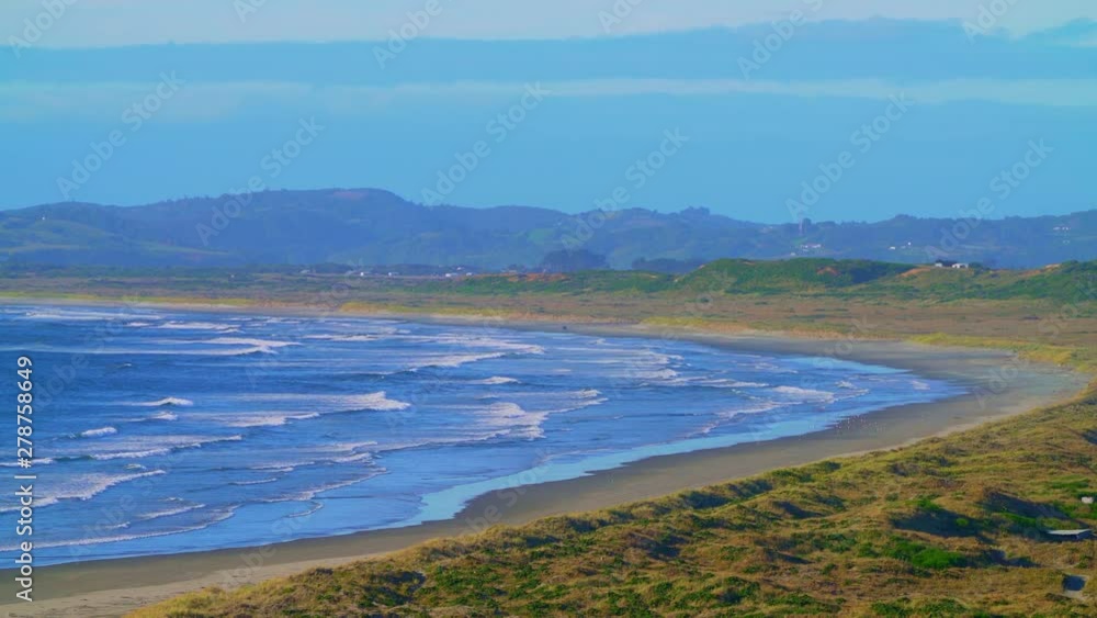 Mar Brava beach on the island of Chiloé on a sunny day and gentle waves of the Pacific Ocean Mar Brava beach on the island of Chiloé on a sunny day and gentle waves of the Pacific Ocean