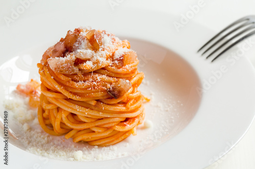 Homemade Amatriciana - Italian pasta based on guanciale (cured pork cheek), pecorino cheese, tomato, white wine,  olive oil. Cucina romana tradizionale. Original recipe fixed by Comune di Amatrice. photo