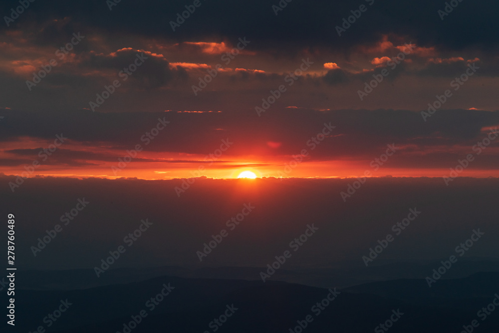 sunrise with clouds, hills silhouette and colorful sky