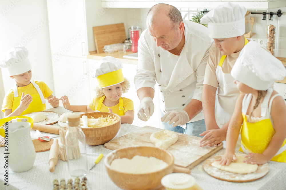 Children cook in the kitchen. Happy child learns to cook in the kitchen delicious chef chef. Children cook in the kitchen. Happy child learns to cook in the kitchen delicious chef chef.