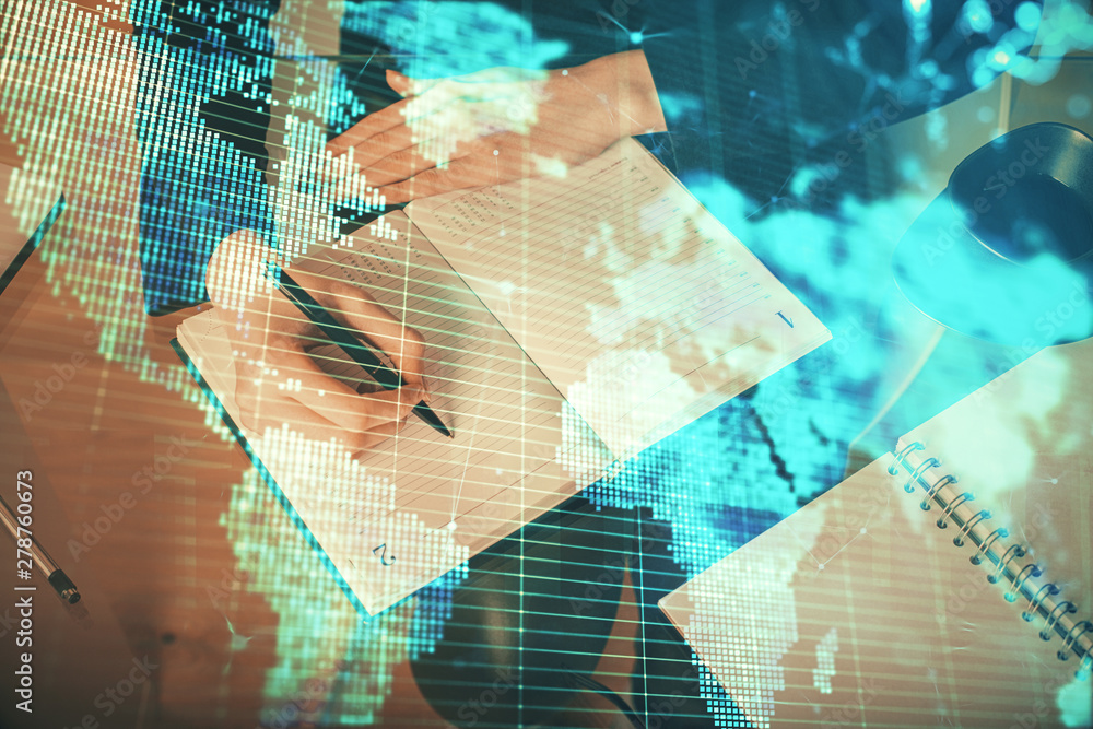 International business hologram over woman's hands taking notes background. Concept of success. Double exposure International business hologram over woman's hands taking notes background. Concept of success. Double exposure