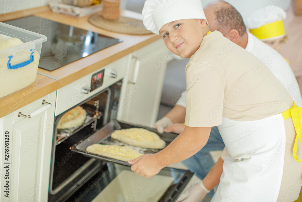 Fototapeta premium Culinary Master Class. Children in the kitchen are cooking. 
