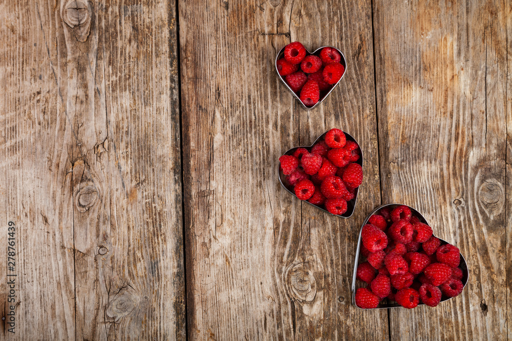Fototapeta premium Ripe raspberries in the shape of a heart
