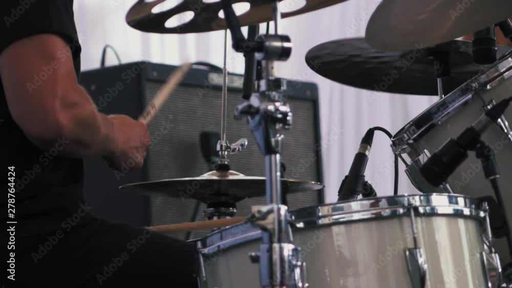 Slow motion shot of a musician performing on drums on festival Slow motion shot of a musician performing on drums on festival