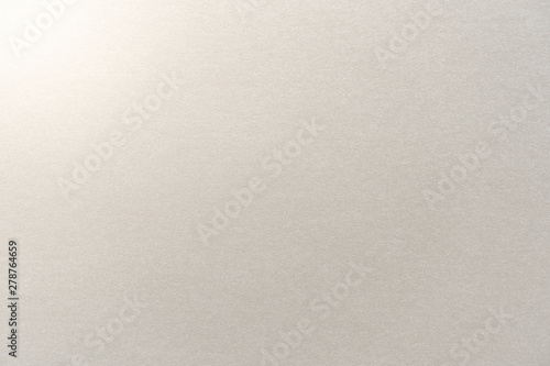 Abstract beige glossy paper texture background or backdrop. Empty light brown cardboard or shiny paperboard for decorative design element. Simple grainy surface for journal template presentation