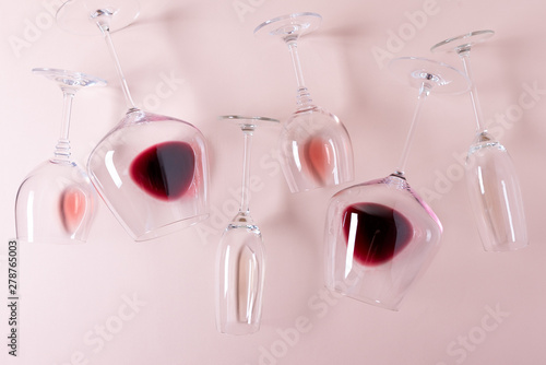 Assorted wineglasses with red, rose and white wine lying on pink background. Wine degustation concept. Flat lay. Top view. Copy space