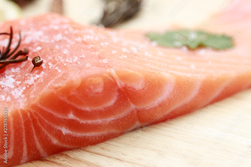 Raw salmon slices with ingredient for cooking on kitchen plate 