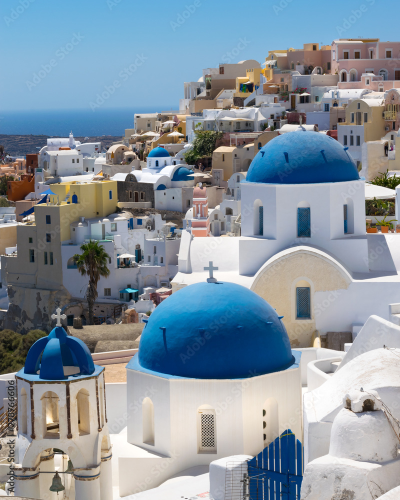 Iconic blue domes and hillside coastline at Oia Santorini