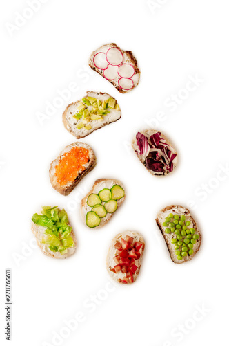 Toast sandwiches with avocado, tomatoes and olives. Isolated on white background. Top view