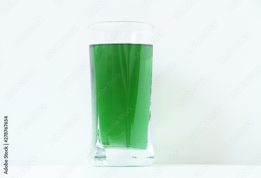 Glass of green liquid on white background, São Paulo, Brazil Glass of green liquid on white background, São Paulo, Brazil