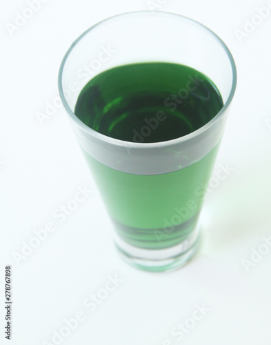 Glass of green liquid on white background, São Paulo, Brazil photo