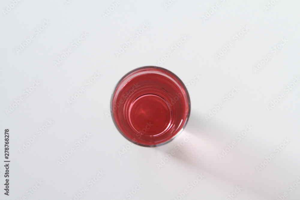 Glass of rose liquid on white background, São Paulo, Brazil Glass of rose liquid on white background, São Paulo, Brazil