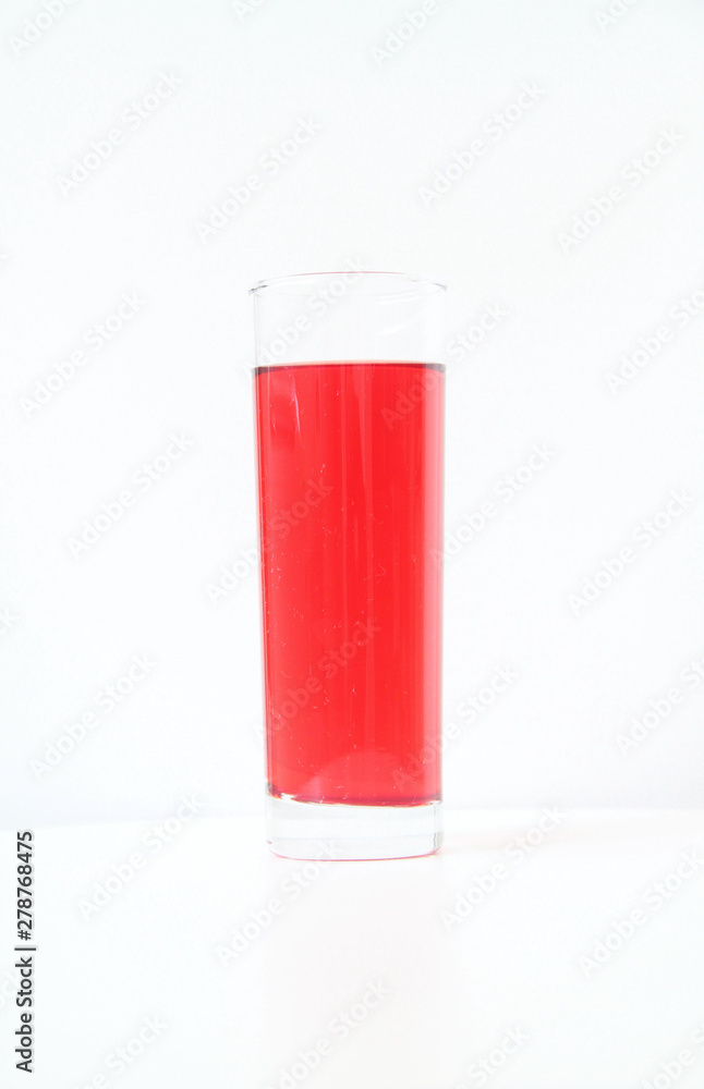 Glass of red liquid on white background, São Paulo, Brazil Glass of red liquid on white background, São Paulo, Brazil