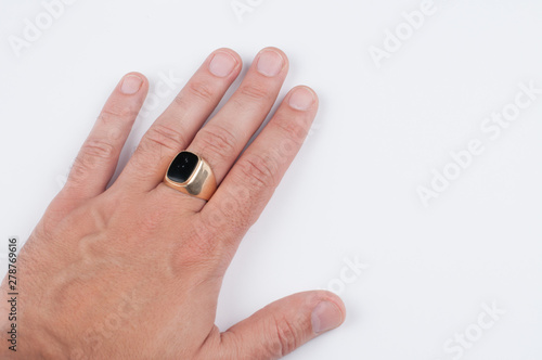 Men's golden ring on his hand isolated on a white background