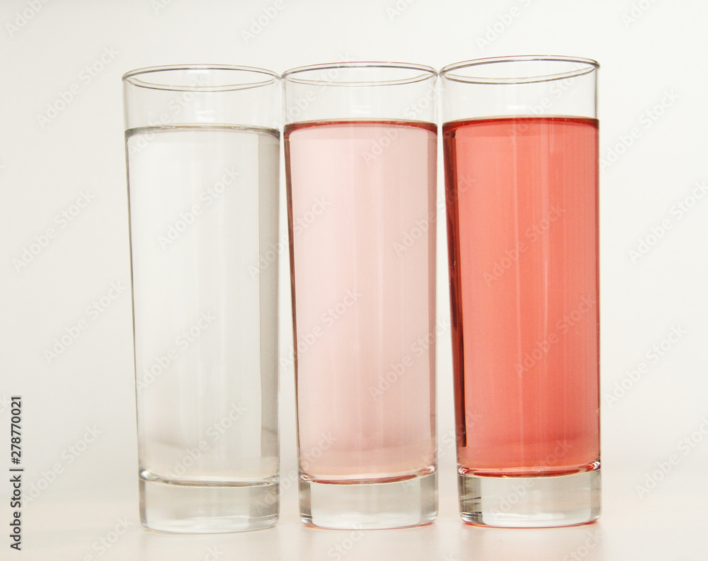 Three glasses of red and transparent liquid on white background, São Paulo, Brazil Three glasses of red and transparent liquid on white background, São Paulo, Brazil