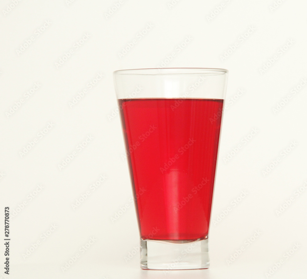 One glass of red liquid on white background, São Paulo, Brazil One glass of red liquid on white background, São Paulo, Brazil