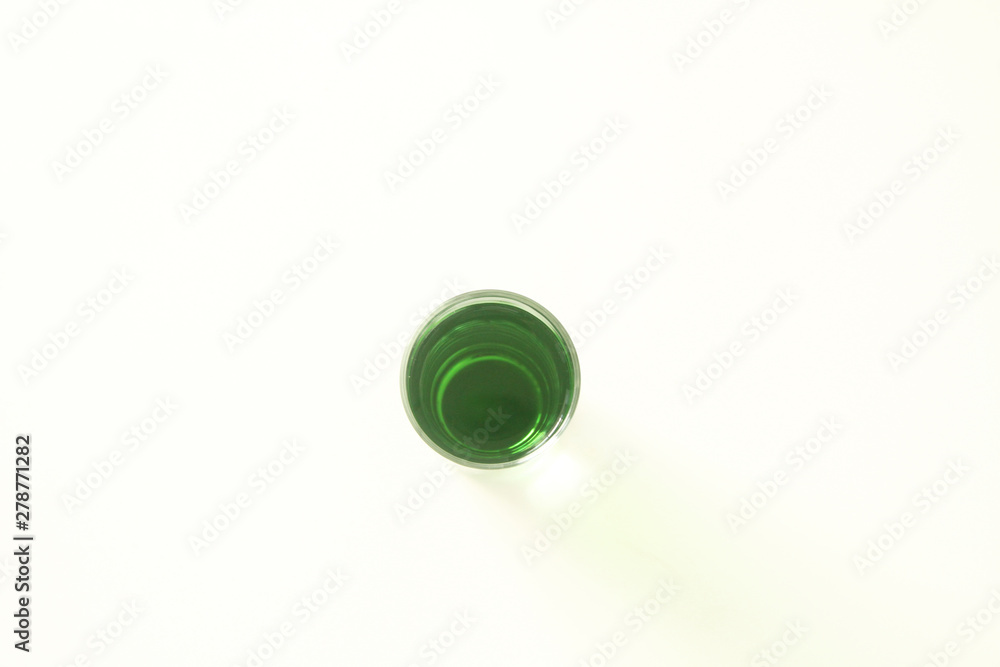 One glass of green liquid on white background, São Paulo, Brazil One glass of green liquid on white background, São Paulo, Brazil