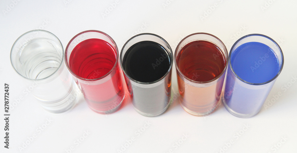 Five Glasses of multicoloured liquid on white background, São Paulo, Brazil Five Glasses of multicoloured liquid on white background, São Paulo, Brazil