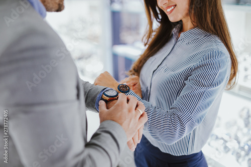 Middle age couple enjoying in shopping at modern jewelry store.