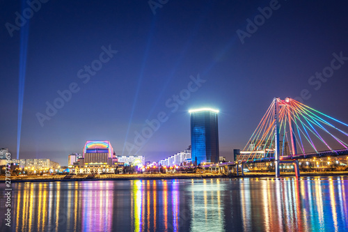 Evening and night Krasnoyarsk, panorama night city. Cable-stayed bridge in bright lights. Urban landscape. photo