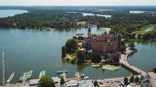 Aerial, drone shot, panning towards the Schwerin Castle and the city, on a sunny summer day, in Germany photo