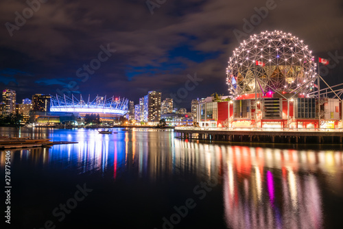 Vancouver skyline at night and reflection in water. British Columbia, Canada.