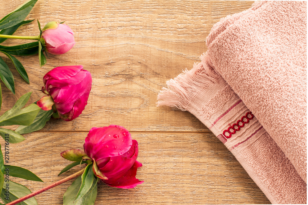 Spa products for facial and body care. Soft terry towel with flowers.