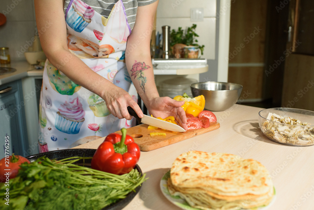 Girl cook makes cutting vegetables for tasty and juicy tortilla Girl cook makes cutting vegetables for tasty and juicy tortilla