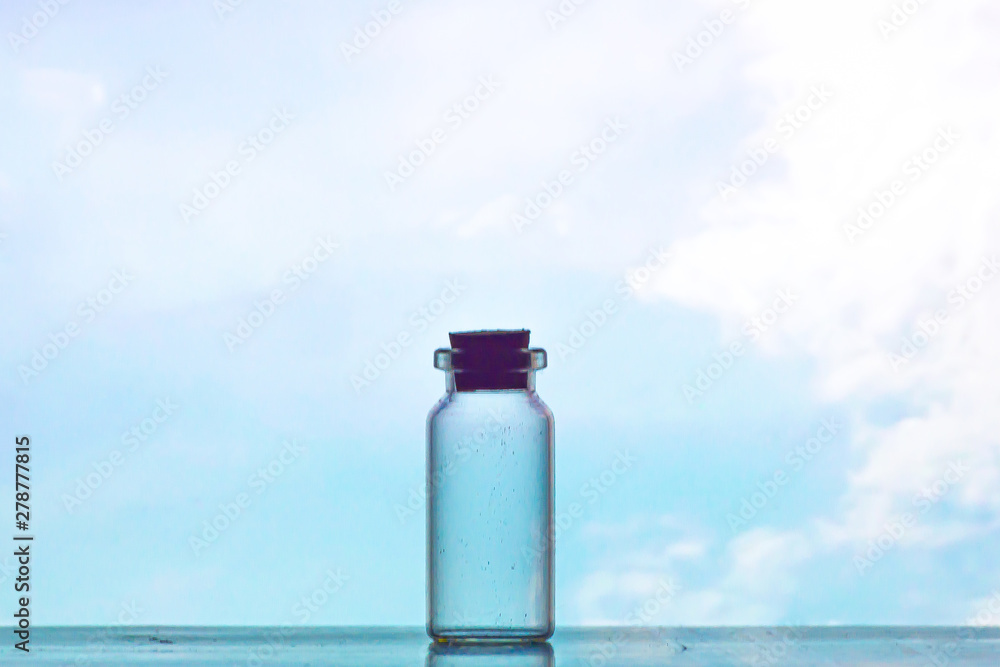 view of silhouette cork and glass bottle with blue sky as background view of silhouette cork and glass bottle with blue sky as background