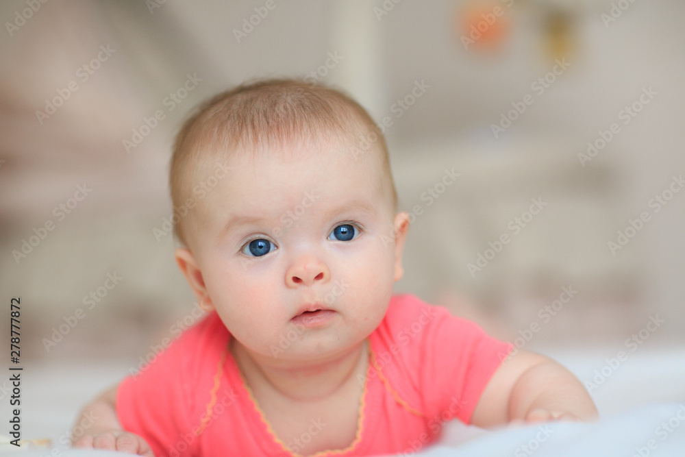 Portrait of pretty baby girl with blue eyes. Cute little baby girl looking into the camera Portrait of pretty baby girl with blue eyes. Cute little baby girl looking into the camera