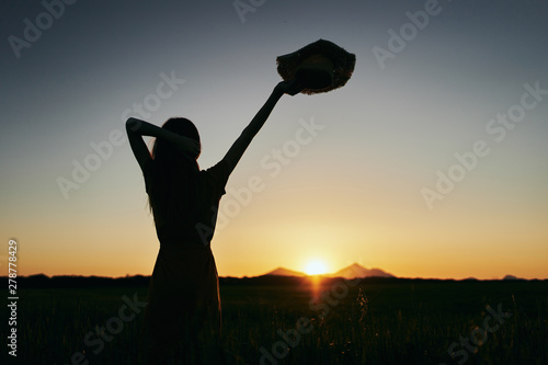 silhouette of golfer on background of sunset sky