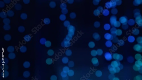 Blurry air bubbles going up in the water and change colour. Round bokeh oxygen bubbles rising up underwater