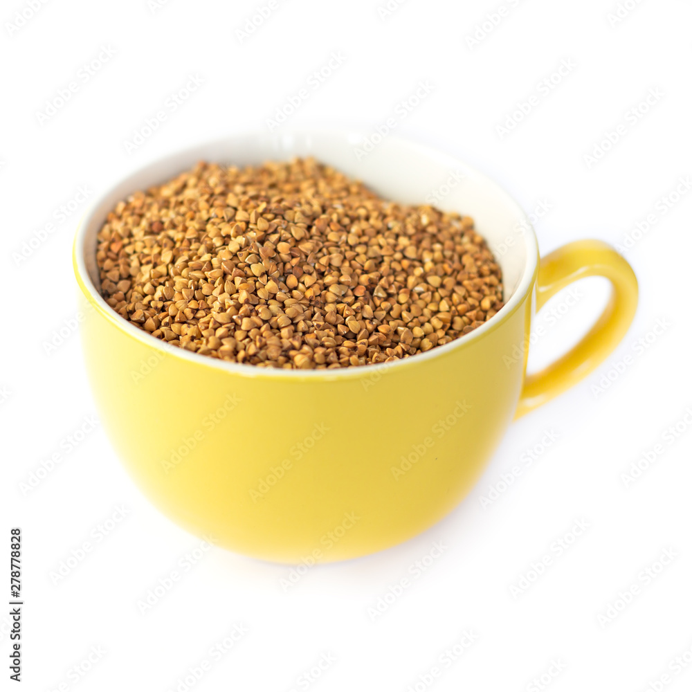 buckwheat grains in a yellow mug, side view, isolated buckwheat grains in a yellow mug, side view, isolated