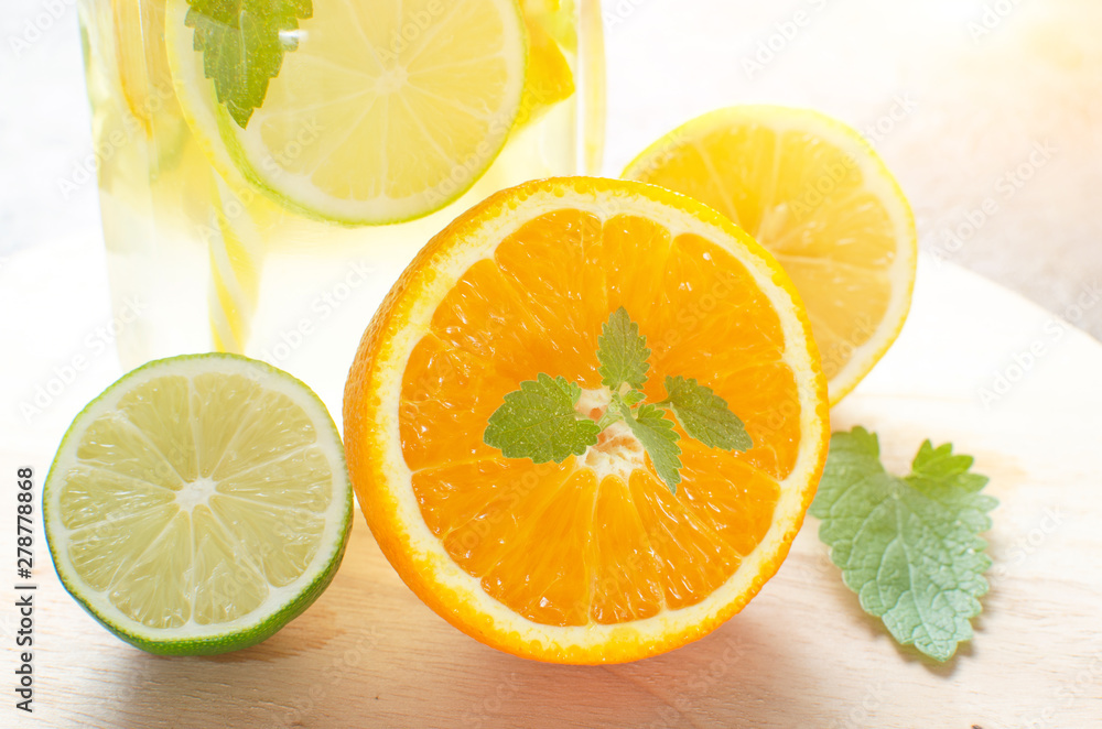 Lemonade of orange, lemon, lime and mint on the background of the contour sunlight. Lemonade of orange, lemon, lime and mint on the background of the contour sunlight.