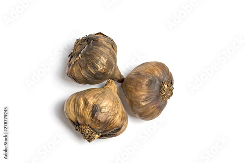 Three black garlics isolated on white