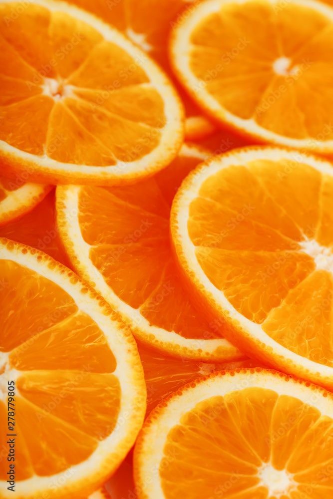 Slices of ripe orange backlit as a textural background. Full screen, close-up, macro Slices of ripe orange backlit as a textural background. Full screen, close-up, macro