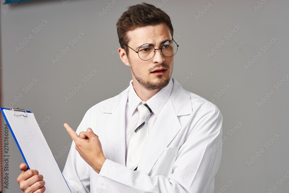 portrait of a doctor writing on clipboard portrait of a doctor writing on clipboard