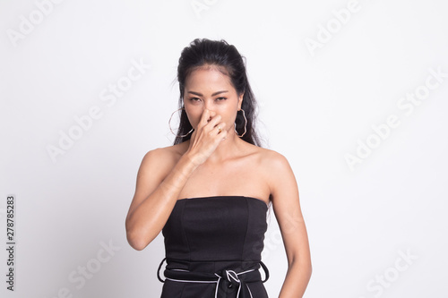 Young Asian woman holding her nose because of a bad smell.