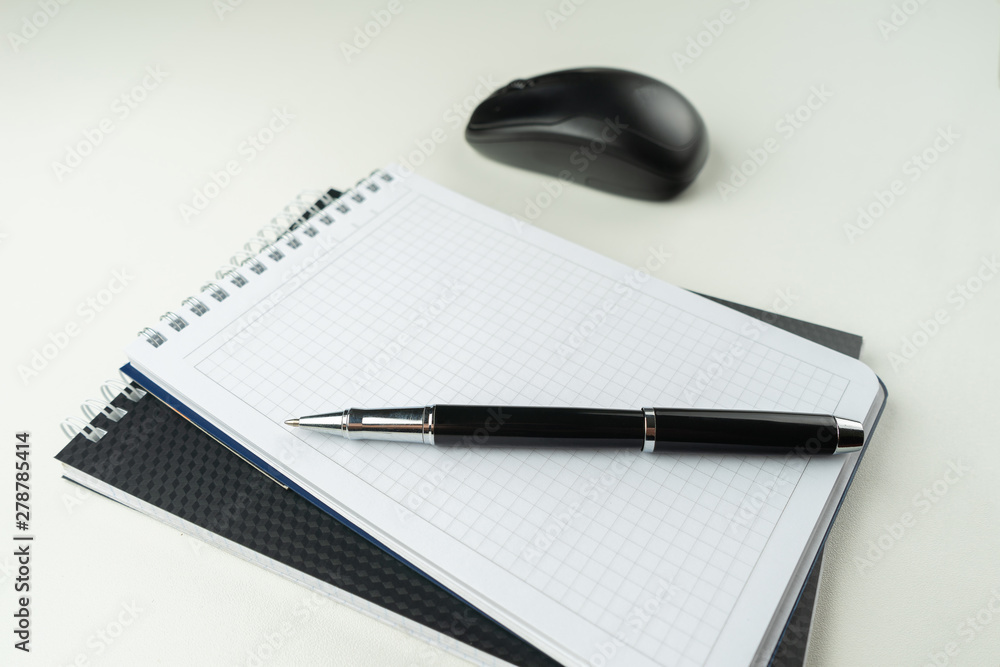 White wooden table with pen, mouse, notebook, . Workspace with copy space. White wooden table with pen, mouse, notebook, . Workspace with copy space.