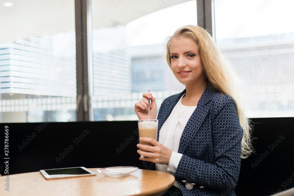 Beautiful woman having a coffee in a cafe