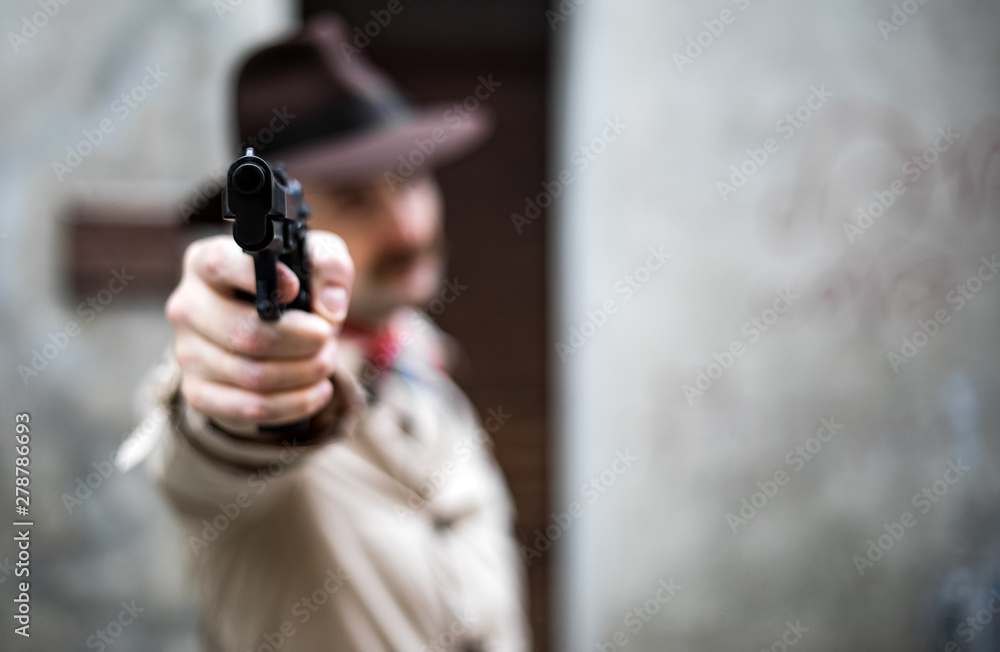 Fotografie Hitman pointing the gun to the camera, execution concept