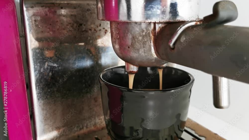 Making Fresh coffee going out from a coffee espresso machine. Shoot on Digital Cinema Camera Making Fresh coffee going out from a coffee espresso machine. Shoot on Digital Cinema Camera