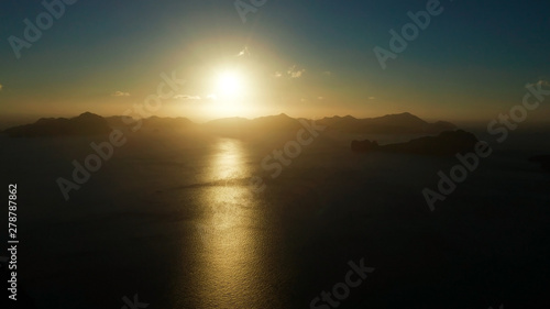 aerial view tropical bay in El Nido at sunset. Seascape with mountains and rocky islands in the morning time. Sunset sky and mountains rocks of bay. sunset over the sea