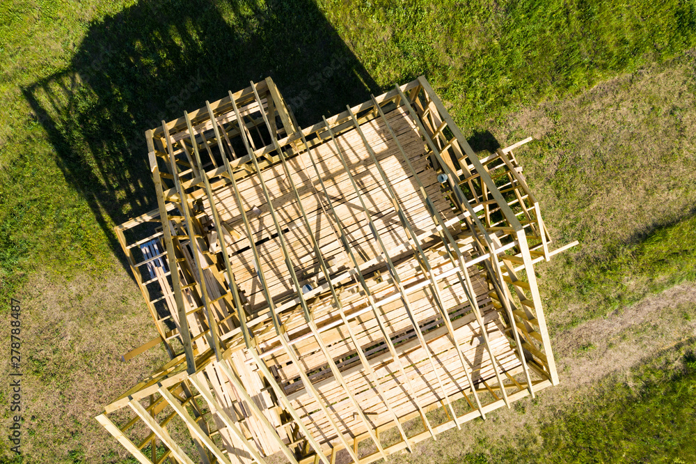 Individual construction of a frame house. The wooden structure on the lake shore is depicted. The view from the top.