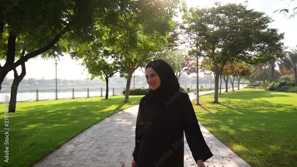 Smiling arab woman enjoying mornig walk in Barsha park in Dubai,UAE. Smiling arab woman enjoying mornig walk in Barsha park in Dubai,UAE.